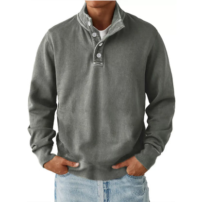 Men's gray long sleeve sweatshirt with button detail and stand collar, paired with light blue jeans